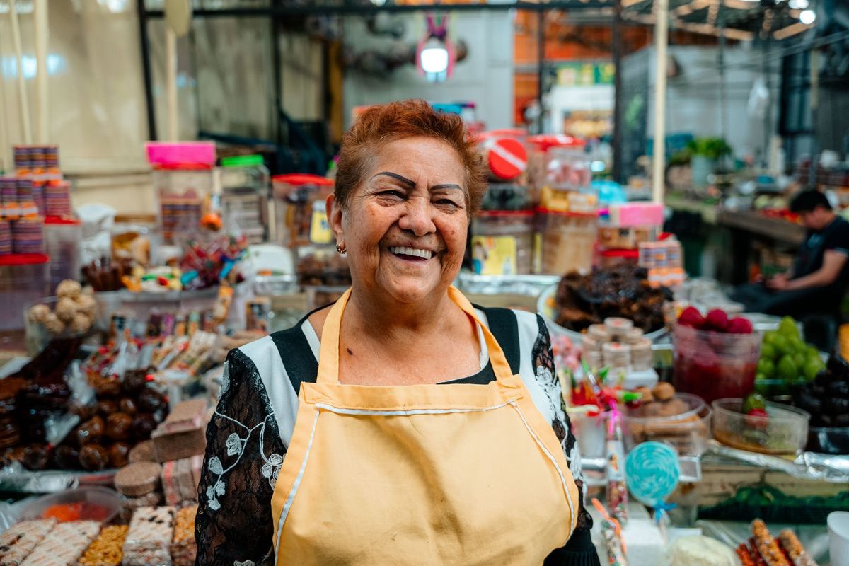 Smiling shop owner at her market stall